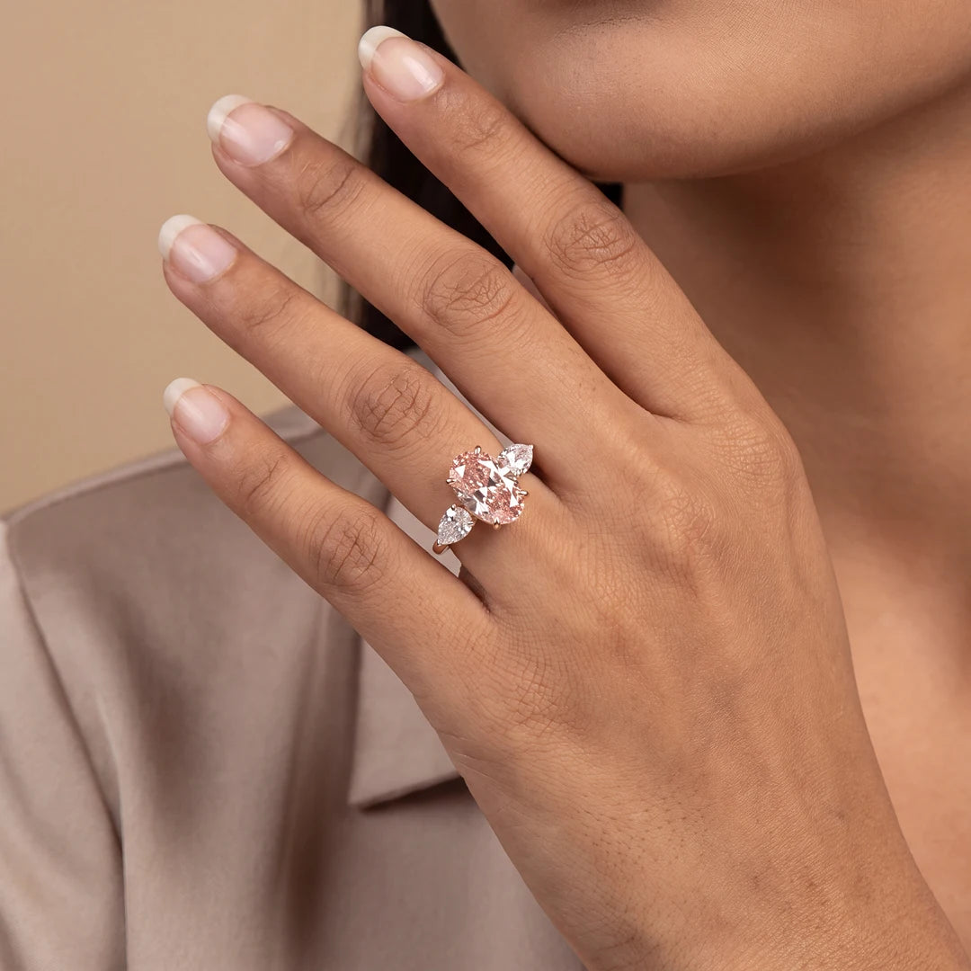 Lifestyle Image of 6.50 CT Oval Cut Pink Diamond Three Stone Ring